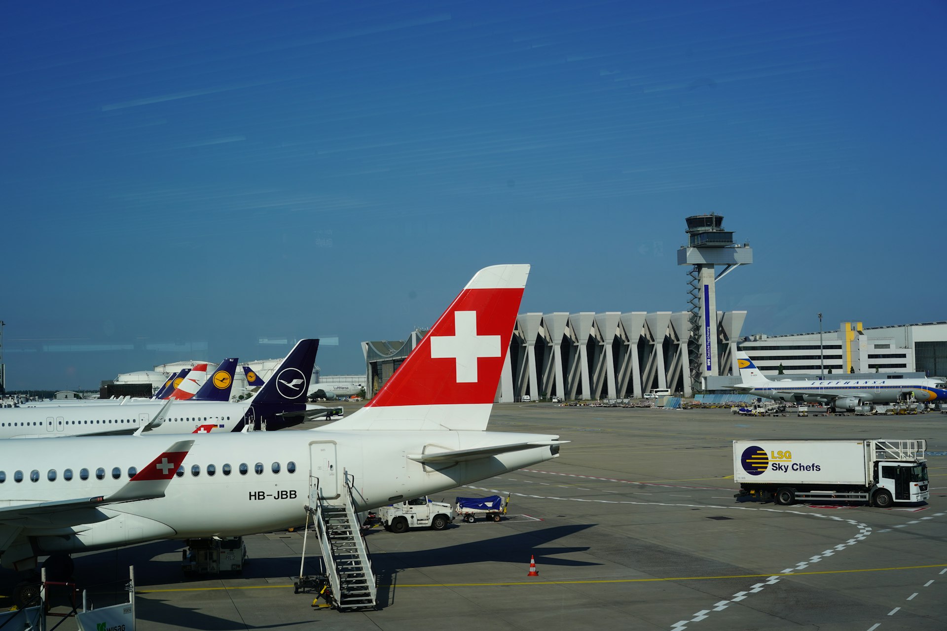 white and red passenger plane on airport during daytime
